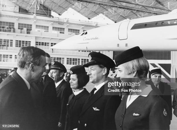 Anthony Wedgwood Benn , the Minister of Technology talks to members of BOAC assigned to the first Concorde flight, during the supersonic airliner's...