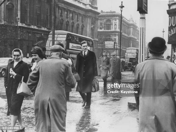 Anthony Wedgwood Benn crosses into Parliament Square on his way to the House of Commons in London, 25th November 1960. He has formally renounced his...