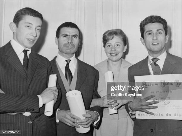 From left to right, Serge Gainsbourg, Jacques Dufilho, Denise Benoit and Marcel Amont with their awards for the best recordings from the AcadÚmie...