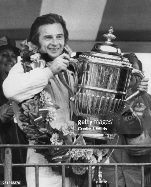 French motorcycle road racer Jean-Pierre Beltoise with the John Player Trophy after winning the John Player Challenge Trophy race at Brands Hatch,...