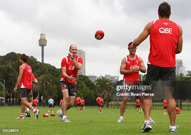 Tadhg Kennelly of the Swans handballs during a Sydney Swans AFL training session at Lakeside Oval on November 18, 2009 in Sydney, Australia. Kennelly...