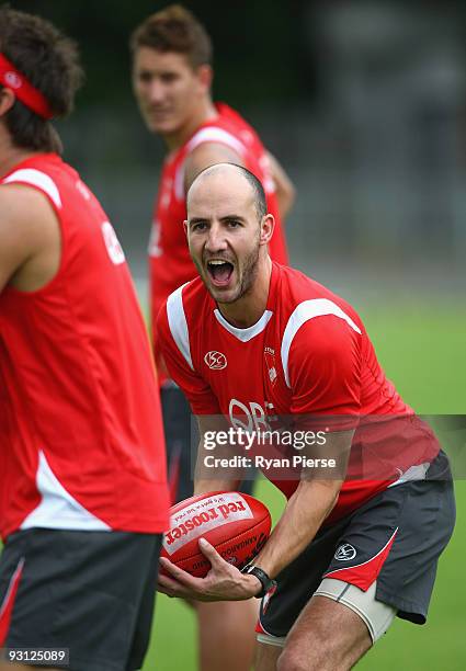 Tadhg Kennelly of the Swans handballs during a Sydney Swans AFL training session at Lakeside Oval on November 18, 2009 in Sydney, Australia. Kennelly...