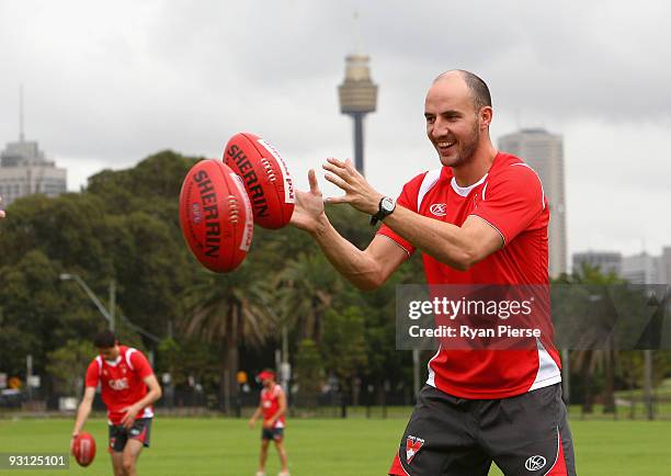 Tadhg Kennelly of the Swans handballs during a Sydney Swans AFL training session at Lakeside Oval on November 18, 2009 in Sydney, Australia. Kennelly...