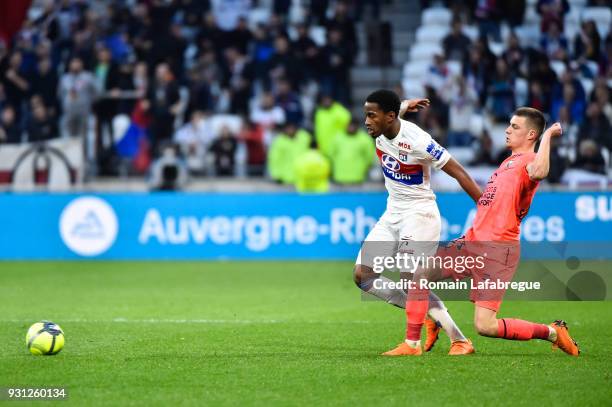 Myziane Maolida of Lyon and Frederic Guilbert of Caen during the Ligue 1 match between Olympique Lyonnais and SM Caen at Parc Olympique on March 11,...