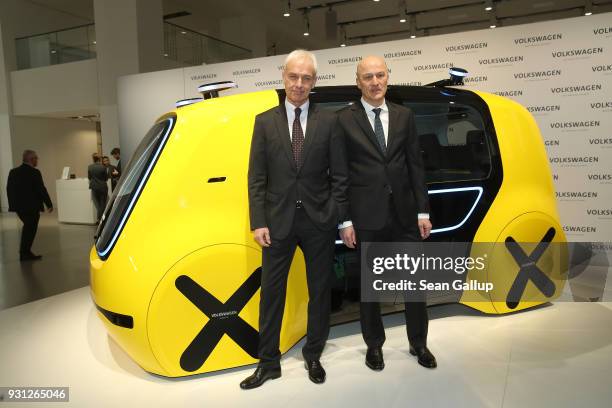 Matthias Mueller , Chairman of German automaker Volkswagen AG, and VW Chief Financial Officer Frank Witter pose at a Volkswagen Sedric autonomous car...