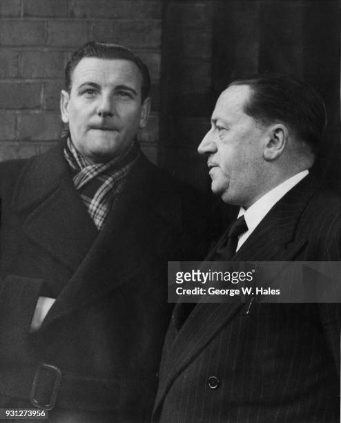 English tenor Webster Booth and BBC producer Leslie Bridgmont attend the funeral of comedian Tommy Handley in Golders Green, north London, 13th...