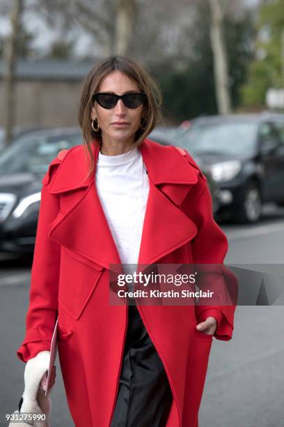 Fashion consultant and blogger Chloé Harrouche of Loulou De Saison wears a Maison Rabih Kayroux coat, Loewe trousers, Adam Selman for Le Specs...