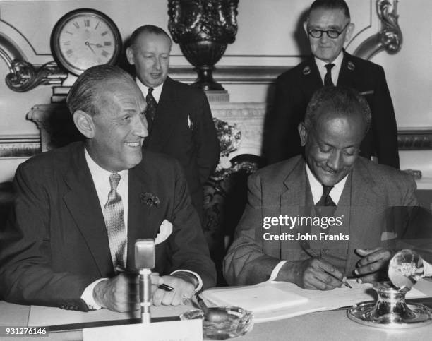 British Conservative politician Alan Lennox-Boyd , the Secretary of State for the Colonies, watches Sir Grantley Herbert Adams , Prime Minister of...