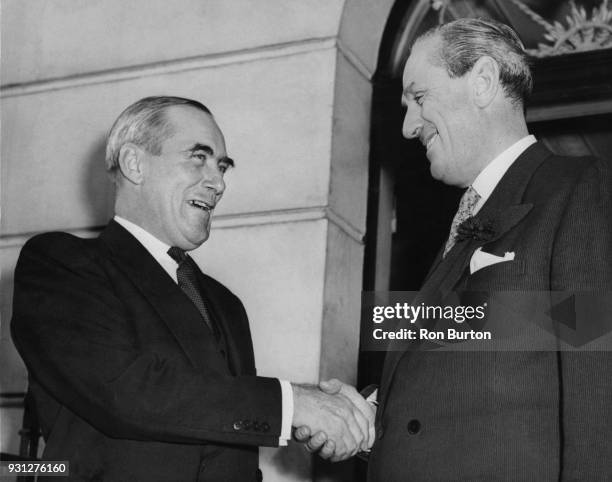 British Conservative politician Alan Lennox-Boyd , the Secretary of State for the Colonies, shakes hands with Sir Hugh Foot after lunching at...