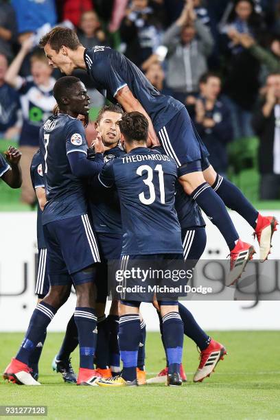 Kosta Barbarouses of the Victory is mobbed after scoring a goal in the dying stages during the AFC Asian Champions League match between the Melbourne...