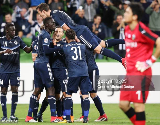 Kosta Barbarouses of the Victory is mobbed after scoring a goal in the dying stages during the AFC Asian Champions League match between the Melbourne...