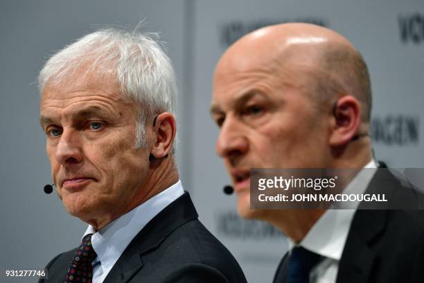 Matthias Mueller , CEO of German car maker Volkswagen , and VW CFO Frank Witter attend their company's annual press conference in Berlin on March 13,...