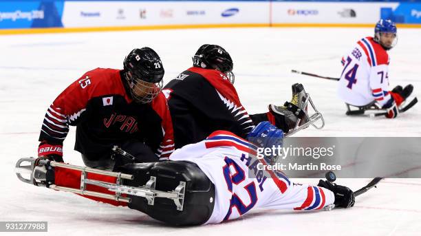 Zdenek Habl of Czech Republic battles for the puck with Eiji Misawa of Japan in the Ice Hockey Preliminary Round - Group B game between Czech...