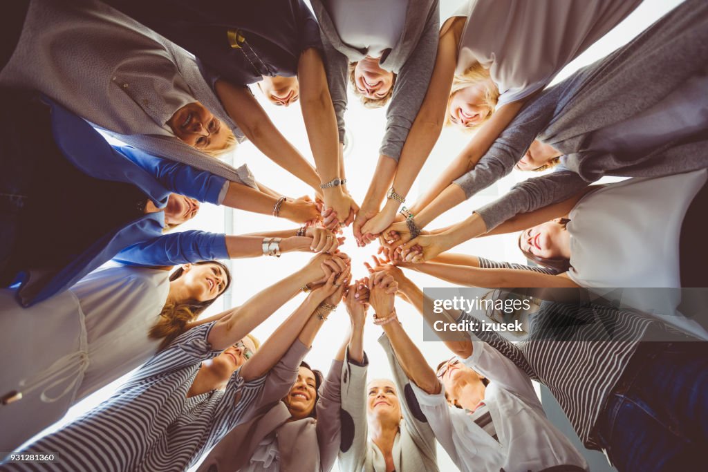 Women’s team. Group of women holding hands