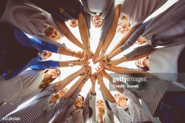 women’s team. group of women holding hands - direito imagens e fotografias de stock