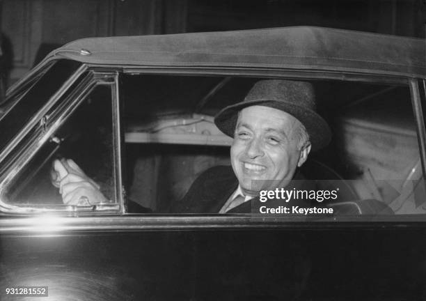 French actor Charles Boyer gets into his car after arriving on the boat train at Saint-Lazare station in Paris, France, 27th March 1953. He is in...