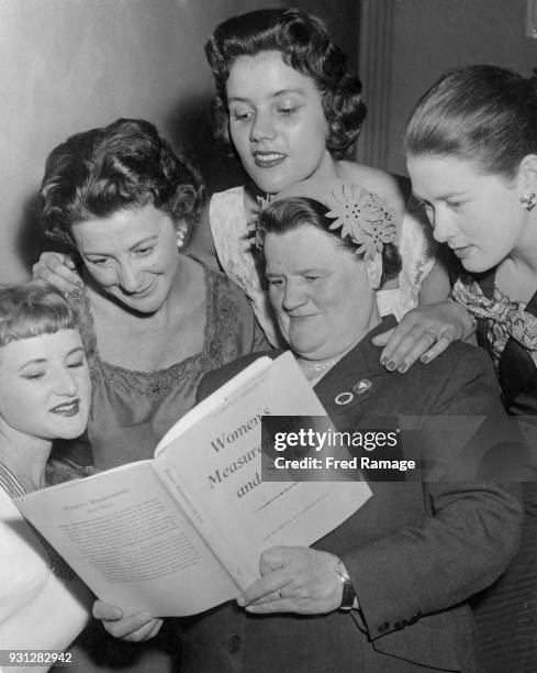 Labour politician Bessie Braddock , the MP for Liverpool Exchange, reads a copy of the new Stationery Office official report on 'Women's Measurements...