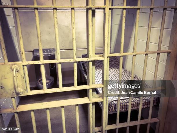 jail cell with the door close - celda fotografías e imágenes de stock