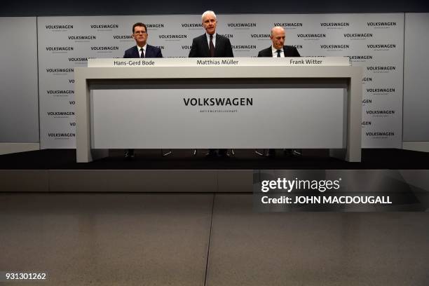 Matthias Mueller , CEO of German car maker Volkswagen , is flanked by VW's CFO Frank Witter and board member Hans-Gerd Bode as he speaks during his...