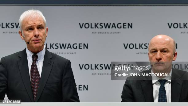 Matthias Mueller , CEO of German car maker Volkswagen , and VW's CFO Frank Witter attend their company's annual press conference in Berlin on March...