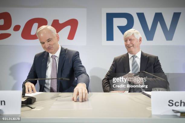 Johannes Teyssen, chief executive officer of EON SE, left, and Rolf Schmitz, chief executive officer of RWE AG, react during a news conference in...