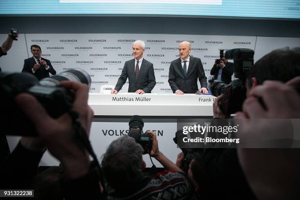 Matthias Mueller, chief executive officer of Volkswagen AG , left, and Frank Witter, chief financial officer of Volkswagen AG , pose for photographs...