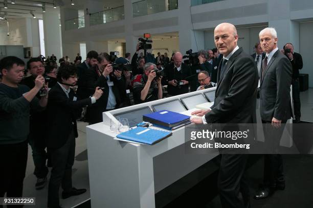 Matthias Mueller, chief executive officer of Volkswagen AG , right, and Frank Witter, chief financial officer of Volkswagen AG , pose for photographs...