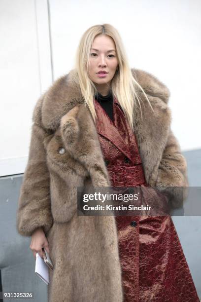 Fashion stylist Tina Leung wears a Koche jacket, Simone Rocha fur coat day 2 of Paris Womens Fashion Week Spring/Summer 2018, on February 27, 2018 in...