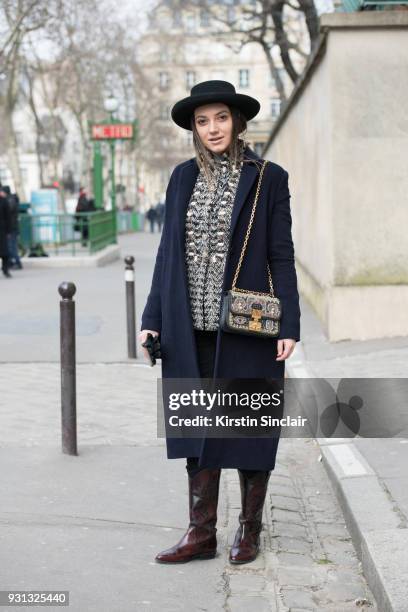 Fashion blogger Andreea Cristea of stilettoshades wears a Dior bag and hat, River Island boots, Coat & Co coat and a Chanel jacket day 2 of Paris...