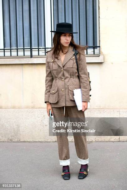 Editor in chief of L’official Ukraine Ulyana Boyko wears a Flow the label suit, Dior hat, Gucci shoes day 2 of Paris Womens Fashion Week...