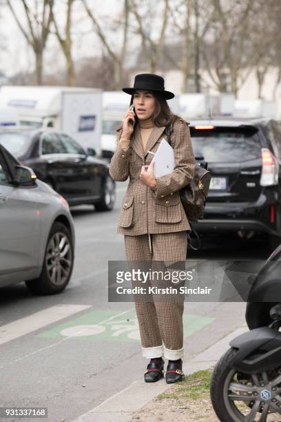Editor in chief of L'official Ukraine Ulyana Boyko wears a Flow the label suit, Dior hat, Gucci shoes and a Louis Vuitton bag day 2 of Paris Womens...