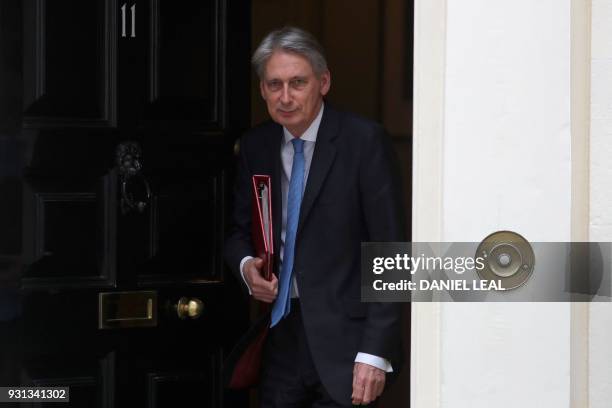 Britain's Chancellor of the Exchequer Philip Hammond leaves from 11 Downing Street in central London on March 13 headed for the Houses of Parliament...