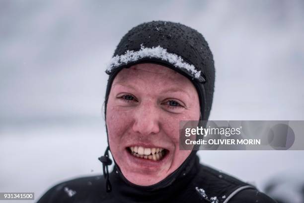 Haege Forfang from Norway poses after a surf session, on March 11 in Unstad northern Norway, Lofoten islands, within Arctic Circle as air temperature...