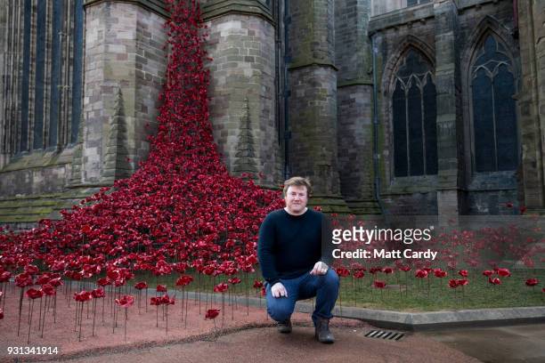 Artist Paul Cummins poses for a photograph with the Weeping Window artwork which opens at Hereford Cathedral as part of the final year of the 14-18...