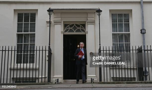 Britain's Chancellor of the Exchequer Philip Hammond leaves from 11 Downing Street in central London on March 13 headed for the Houses of Parliament...