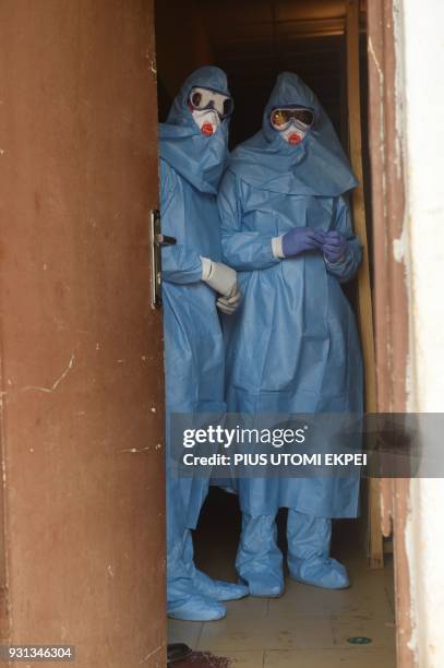 Health officials wear protective gear to tend to Lassa fever patients at the Institute of Lassa Fever Research and Control in Irrua Specialist...