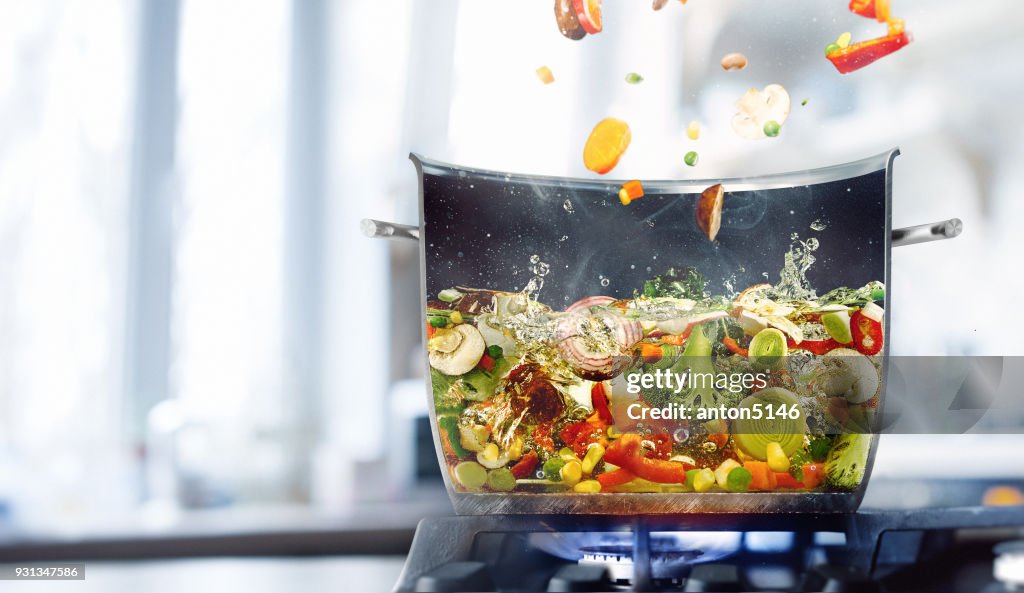 Vegetable broth in a half of saucepan