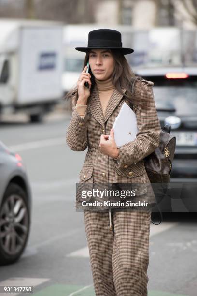 Editor in chief of L'official Ukraine Ulyana Boyko wears a Flow the label suit, Dior hat and a Louis Vuitton bag day 2 of Paris Womens Fashion Week...