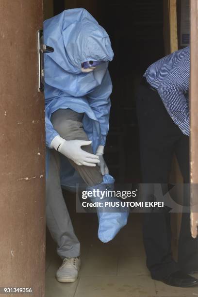Health official puts on protective gear to tend to Lassa fever patients at the Institute of Lassa Fever Research and Control in Irrua Specialist...