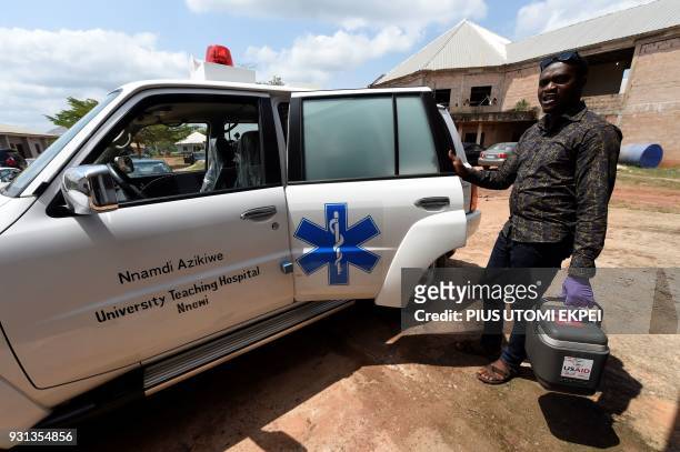 Health worker arrives with a cooler containing blood samples for testing at the Institute of Lassa Fever Research and Control in Irrua Specialist...