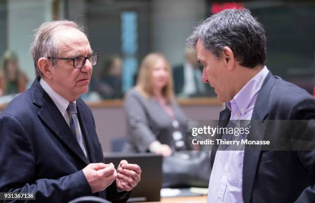 Italian Minister Economy & Finance Pier Carlo Padoan is talking with the Greek Finance Minister Euclid Tsakalotos prior an EU EcoFin Ministers...