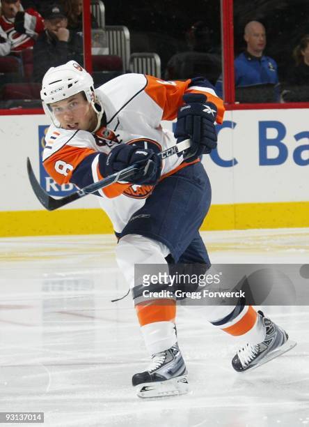 Bruno Gervais of the New York Islanders fires the puck into the offensive zone during a NHL game on November 11, 2009 at RBC Center in Raleigh, North...