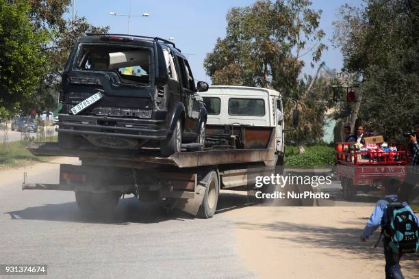 Damaged vehicle is removed from the site of an explosion that occurred as the convoy of Palestinian Prime Minister Rami Hamdallah entered Gaza...