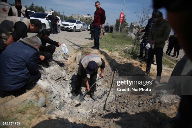 Hamas security services personnel inspect the site of a Tuesday explosion that occurred as the convoy of Palestinian Prime Minister Rami Hamdallah...