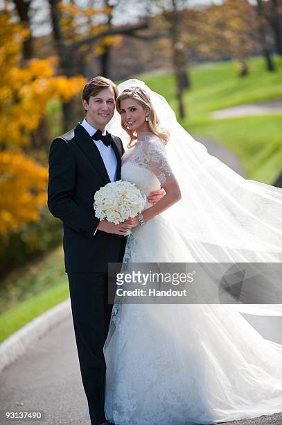 In this handout image provided by Ivanka Trump and Jared Kushner, Ivanka Trump and Jared Kushner attend their wedding at Trump National Golf Club on...