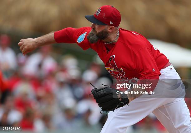 Jason Motte of the St. Louis Cardinals in action against the Miami Marlins during a spring training game against the Miami Marlins at Roger Dean...