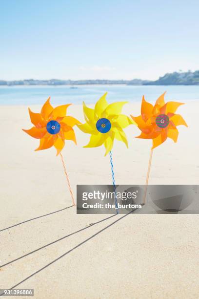 colorful pinwheel toys on the beach - ciboure stock-fotos und bilder