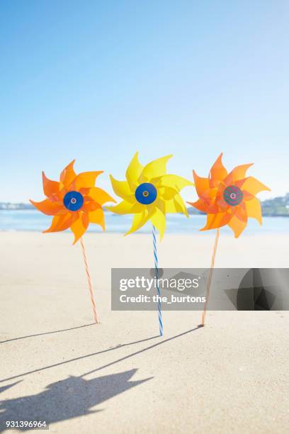 colorful pinwheel toys on the beach - ciboure stock-fotos und bilder