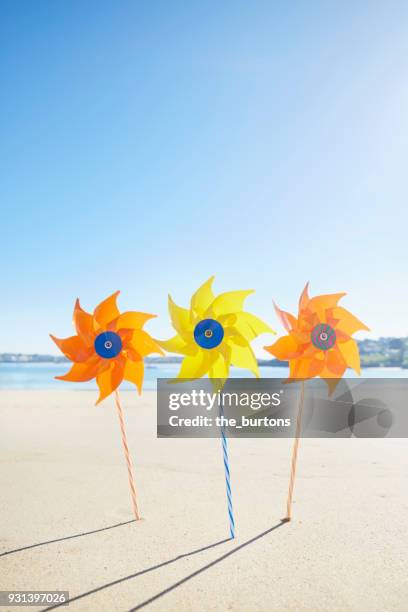 colorful pinwheel toys on the beach - ciboure stock-fotos und bilder