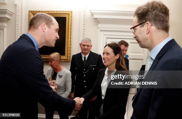 Britain's Prince William, Duke of Cambridge, talks with police officers including PC Shaun Cartrightm, who collected the Outstanding Bravery Award,...